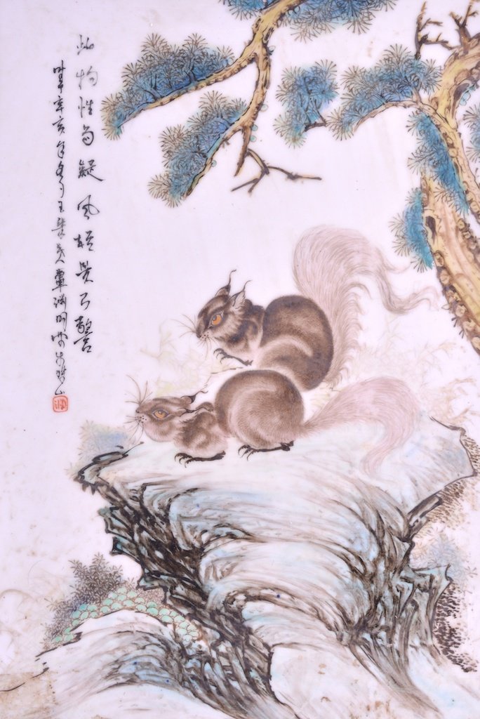 MANNER OF BI YUAN MING (1907-1990) A CHINESE PORCELAIN: MANNER OF BI YUAN MING (1907-1990) A CHINESE PORCELAIN PANEL OF SQUIRRELS modelled seated upon hollow rock within a landscape. Signed. 1ft 2.5ins x 10ins.
