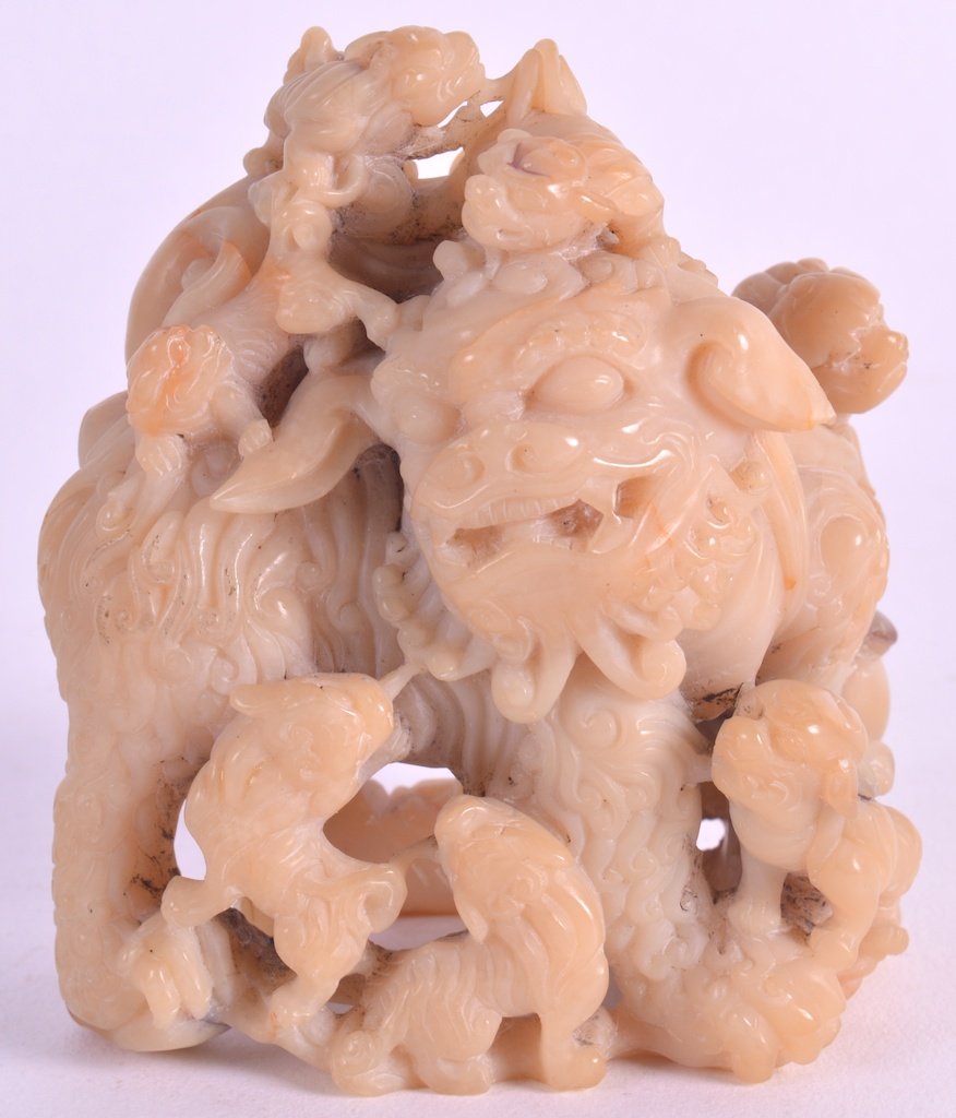 A 19TH CENTURY CHINESE CARVED SOAPSTONE FIGURAL GROUP: A 19TH CENTURY CHINESE CARVED SOAPSTONE FIGURAL GROUP depicting numerous buddhistic lions clambering upon a large beast. 3.5ins high.