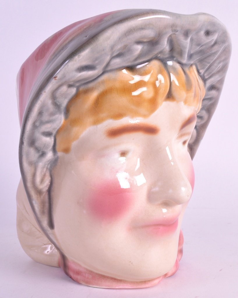 A RARE SARREGUEMINES SUFFRAGETTE CHARACTER JUG with: A RARE SARREGUEMINES SUFFRAGETTE CHARACTER JUG with rosy cheeks. 6.25ins high.