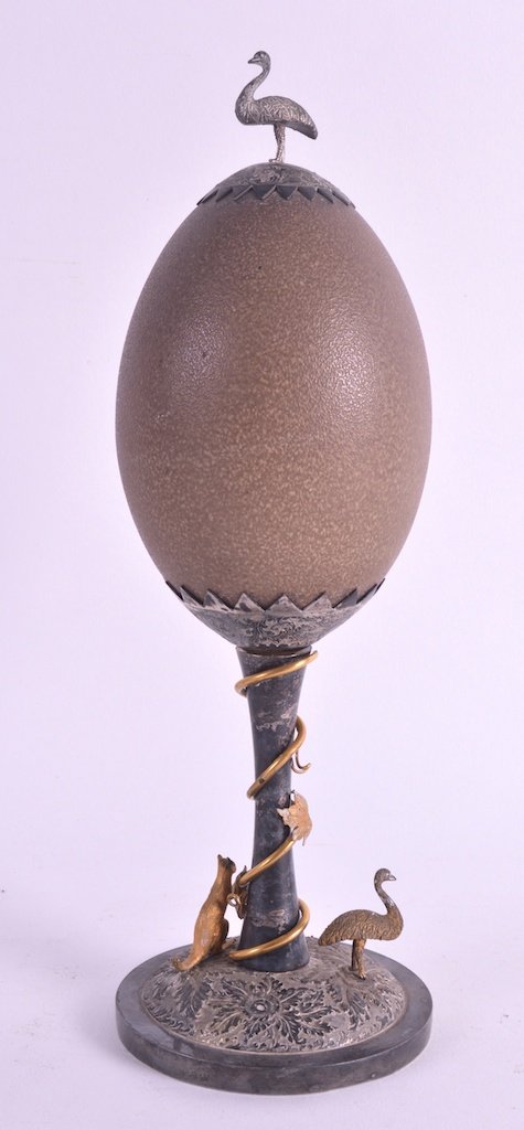 A LATE 19TH CENTURY AUSTRALIAN SILVER PLATED EMU EGG ON: A LATE 19TH CENTURY AUSTRALIAN SILVER PLATED EMU EGG ON STAND the base surmounted with an emu and kangaroo. 11.5ins wide.