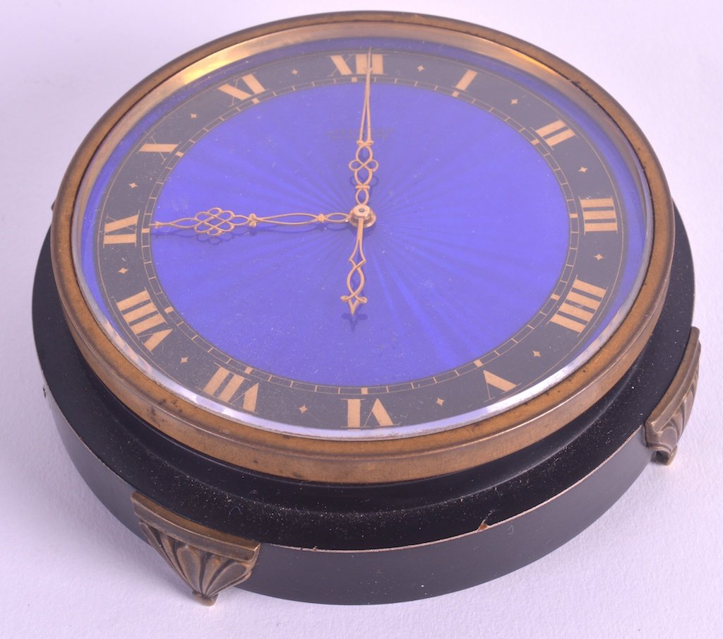 A 1930S SWISS GILT METAL AND BLUE ENAMEL CIRCULAR DESK: A 1930S SWISS GILT METAL AND BLUE ENAMEL CIRCULAR DESK CLOCK by Bittmann of St Moritz, the enamel dial decorated with gilt numerals. 4.5ins diameter.
