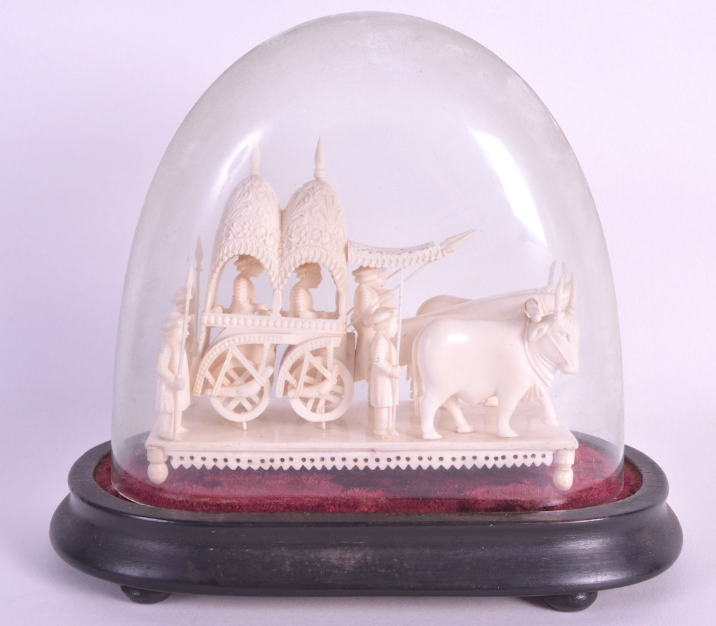 AN EARLY 20TH CENTURY INDIAN CARVED IVORY CEREMONIAL: AN EARLY 20TH CENTURY INDIAN CARVED IVORY CEREMONIAL CART modelled being pulled by oxen.5.5ins wide. £200-300.