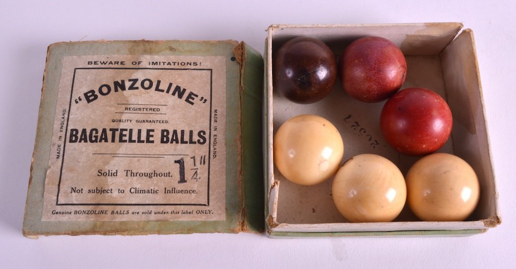 A GROUP OF SIX EDWARDIAN CARVED IVORY BAGATELLE BALLS: A GROUP OF SIX EDWARDIAN CARVED IVORY BAGATELLE BALLS in original box. (6)