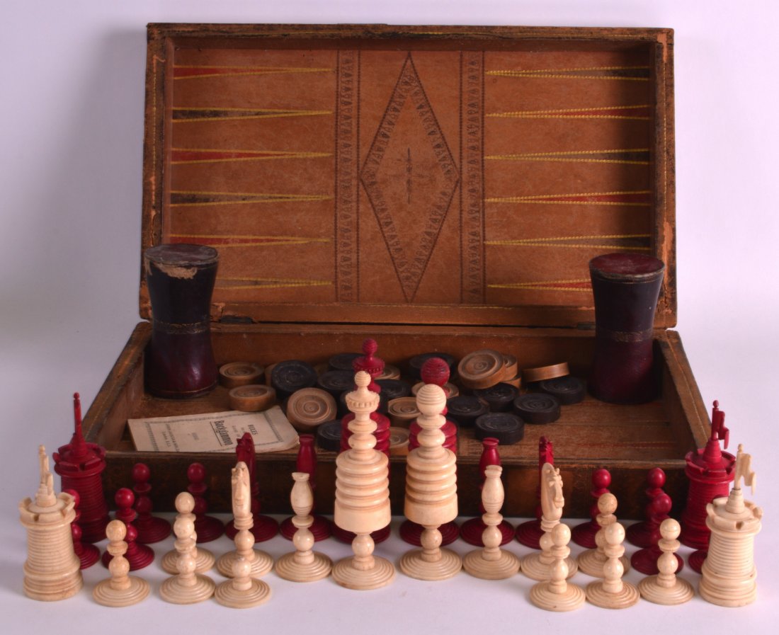 A RARE 19TH CENTURY NORTHERN UPRIGHT JACQUES CARVED: A RARE 19TH CENTURY NORTHERN UPRIGHT JACQUES CARVED BONE CHESS SET contained within a leather effect wooden box.