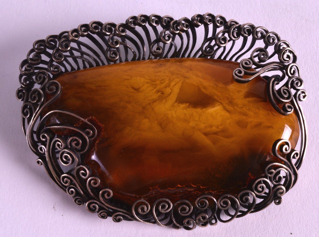 A CHINESE WHITE METAL MOUNTED AMBER BROOCH of (1 of 1)