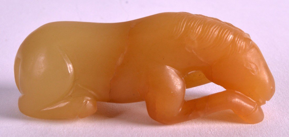 A CHINESE QING DYNASTY YELLOW JADE FIGURE OF A HORSE (1 of 3)