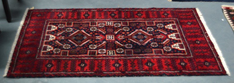 A MID 20TH CENTURY AFGHAN TYPE RUG decorated with (1 of 3)