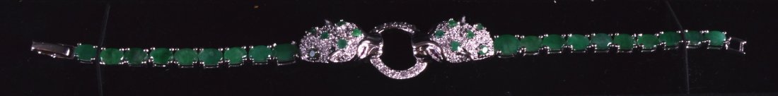 A SILVER AND EMERALD PANTHER BRACELET.: A SILVER AND EMERALD PANTHER BRACELET.