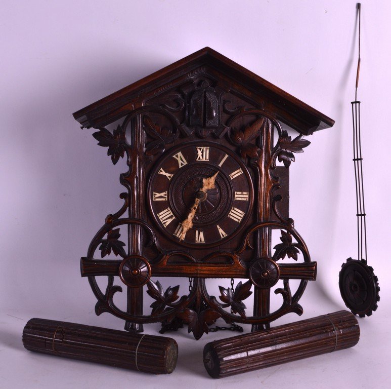 A GOOD 19TH CENTURY BAVARIAN BLACK FOREST CUCKOO CLOCK: A GOOD 19TH CENTURY BAVARIAN BLACK FOREST CUCKOO CLOCK unusually well carved with scrolling foliage and vines. 1Ft 2ins high.