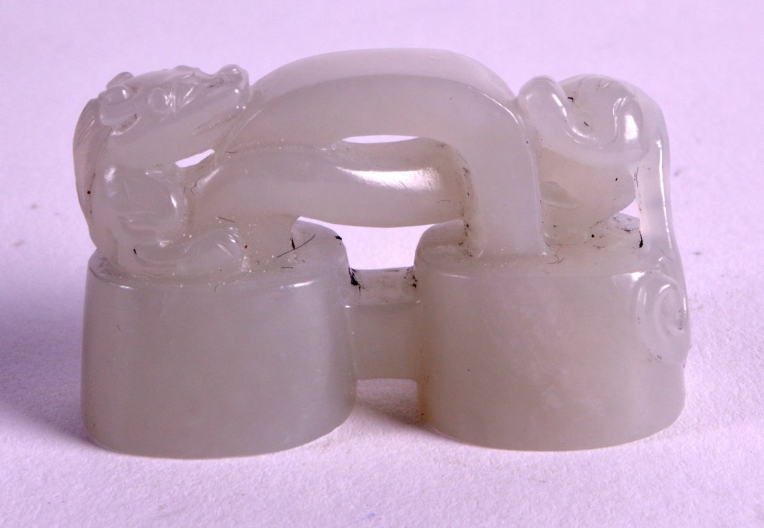 A SMALL CHINESE CARVED PALE GREEN JADE SEAL surmounted (1 of 2)