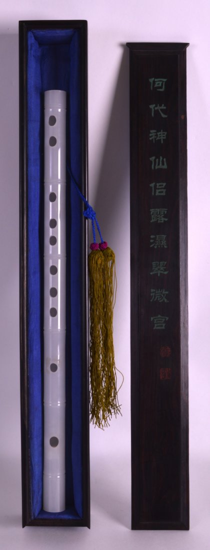 A CHINESE CARVED WHITE JADE FLUTE 20th Century, (1 of 2)