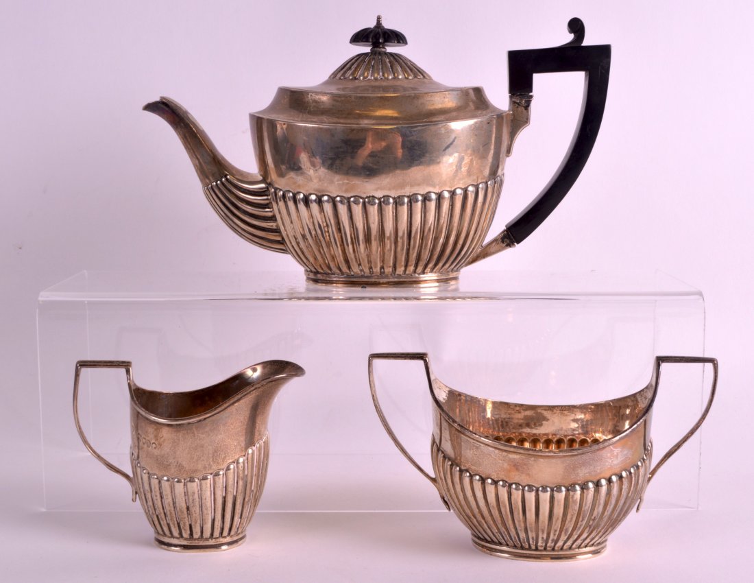 A VICTORIAN THREE PIECE SILVER TEASET with reeded lower (1 of 1)