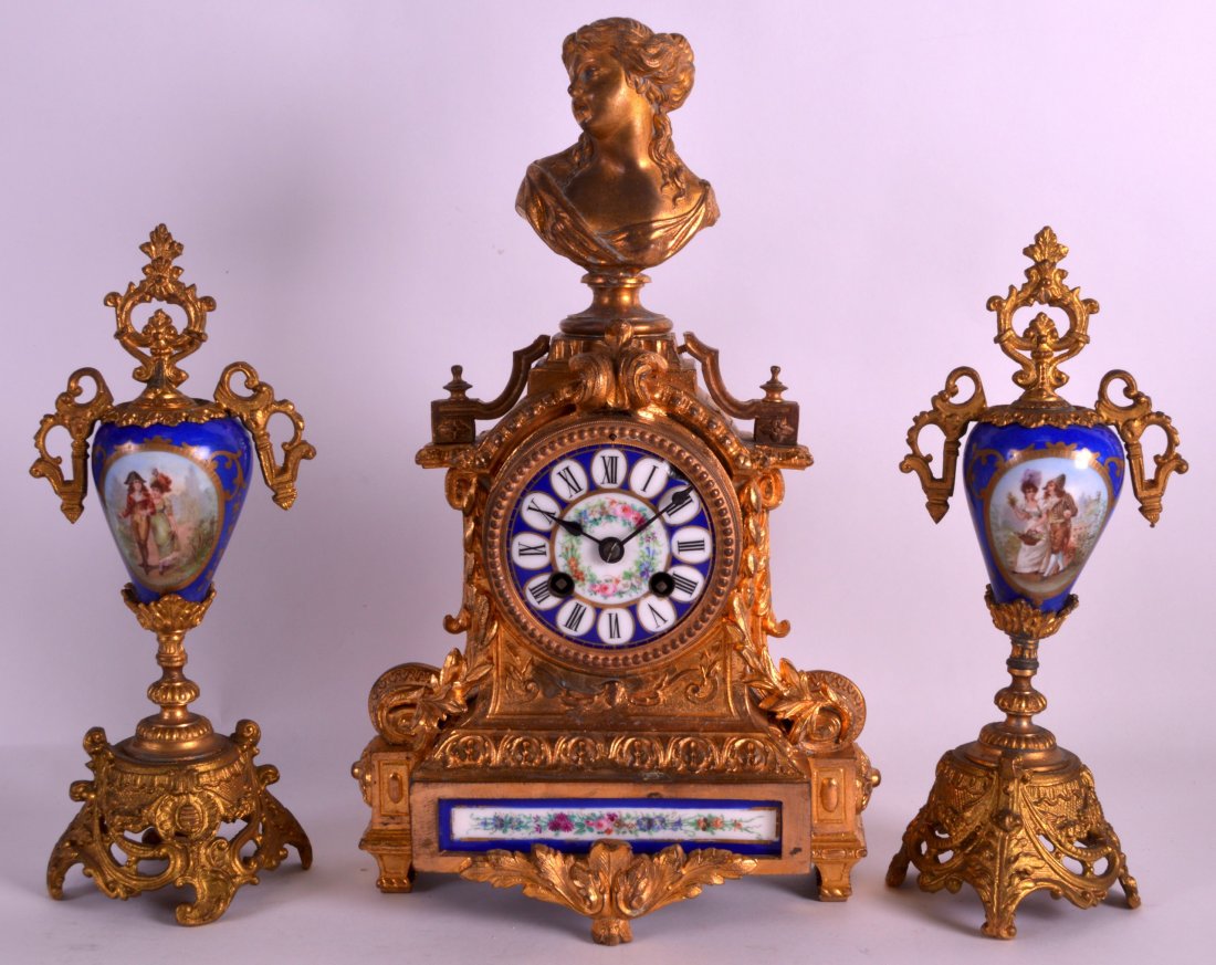 A 19TH CENTURY FRENCH GILT METAL AND PORCELAIN CLOCK: A 19TH CENTURY FRENCH GILT METAL AND PORCELAIN CLOCK GARNITURE painted with scenes of romantic figures within landscapes. Mantel 1ft 2ins high.