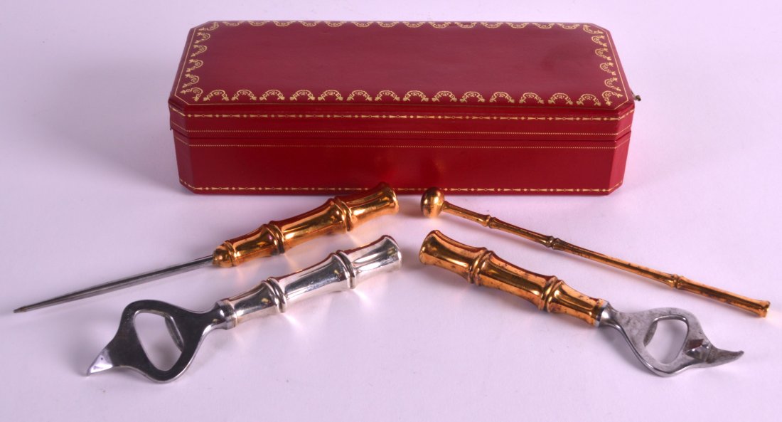 A SET OF FOUR SILVER GILT TIFFANY BAR TOOLS within a: A SET OF FOUR SILVER GILT TIFFANY BAR TOOLS within a cartier box. (4)