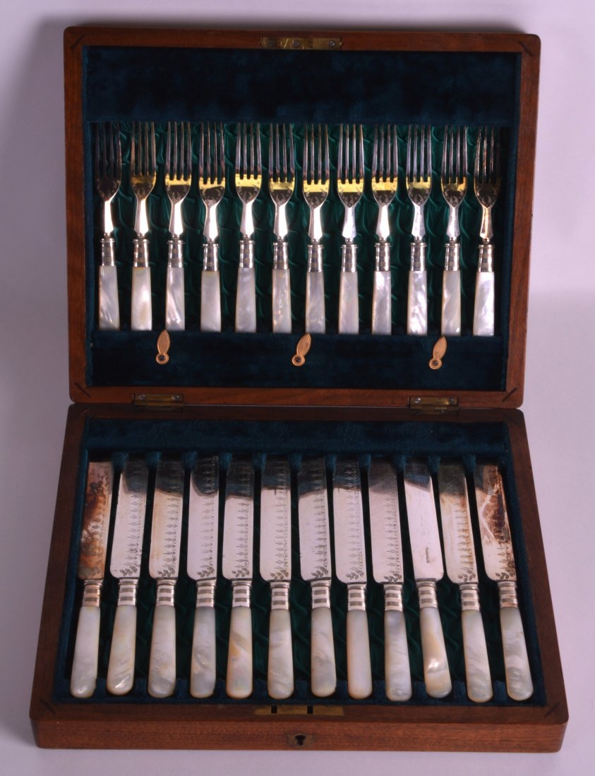A LOVELY SET OF EDWARDIAN SILVER BLADED KNIVES AND: A LOVELY SET OF EDWARDIAN SILVER BLADED KNIVES AND FORKS with mother of pearl handles.
