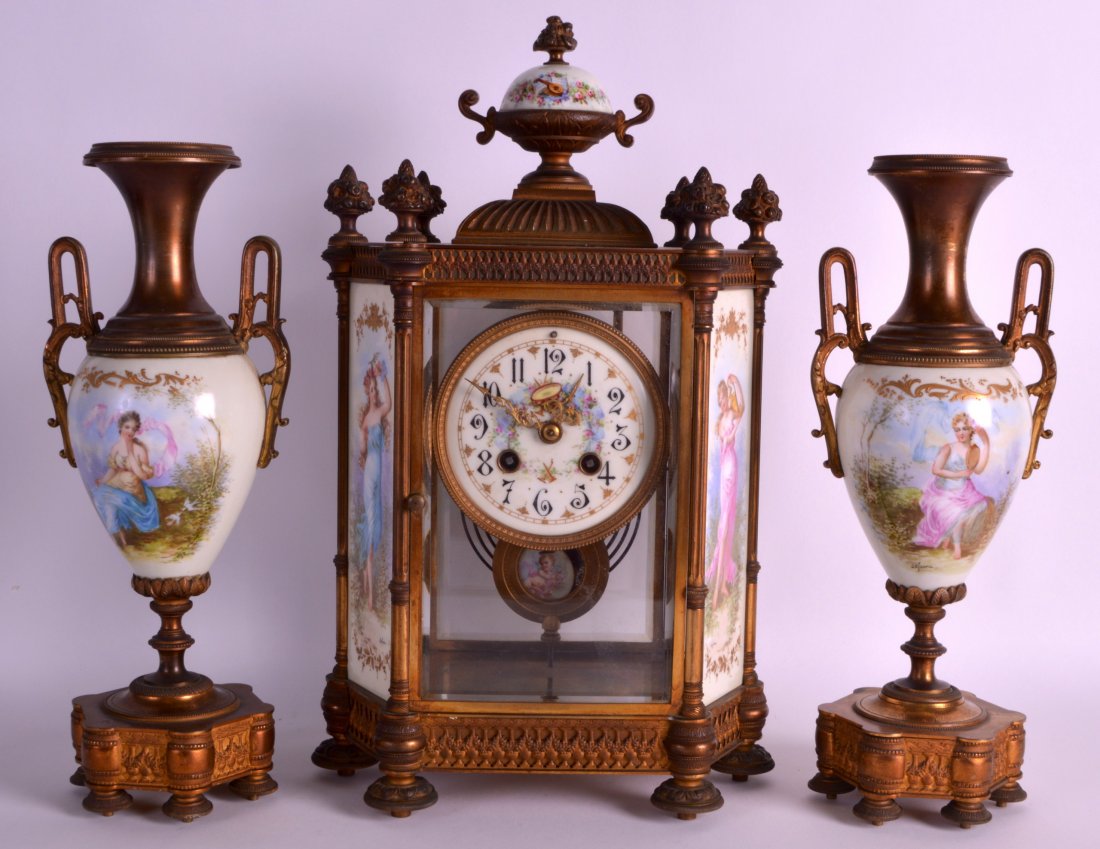 A STUNNING 19TH CENTURY FRENCH ORMOLU AND SEVRES: A STUNNING 19TH CENTURY FRENCH ORMOLU AND SEVRES PORCELAIN CLOCK GARNITURE decorated with finely painted panels of classical females within landscapes. 1Ft 3.5ins high.