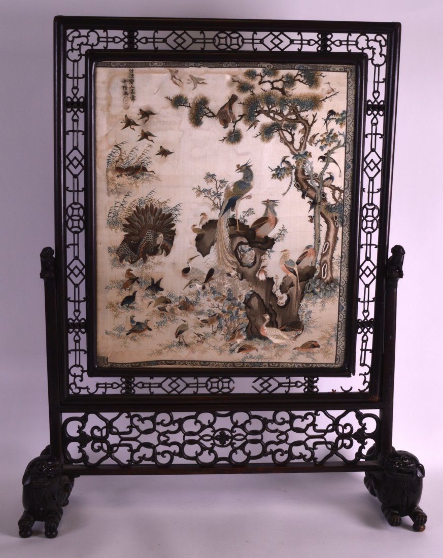 A FINE 19TH CENTURY CHINESE SILKWORK SCREEN ON STAND: A FINE 19TH CENTURY CHINESE SILKWORK SCREEN ON STAND Qing, decorated with birds standing upon hollow rock within a landscape. Overall 2ft 8ins x 2ft 1ins.