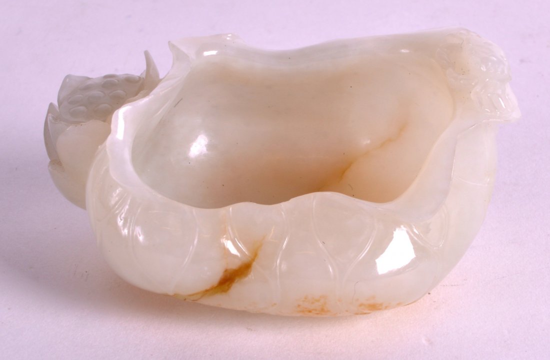 A CHINESE CARVED WHITE JADE BRUSH WASHER probably late: A CHINESE CARVED WHITE JADE BRUSH WASHER probably late Qing, of naturalistic form, overlaid with a crab. 3.25ins wide.