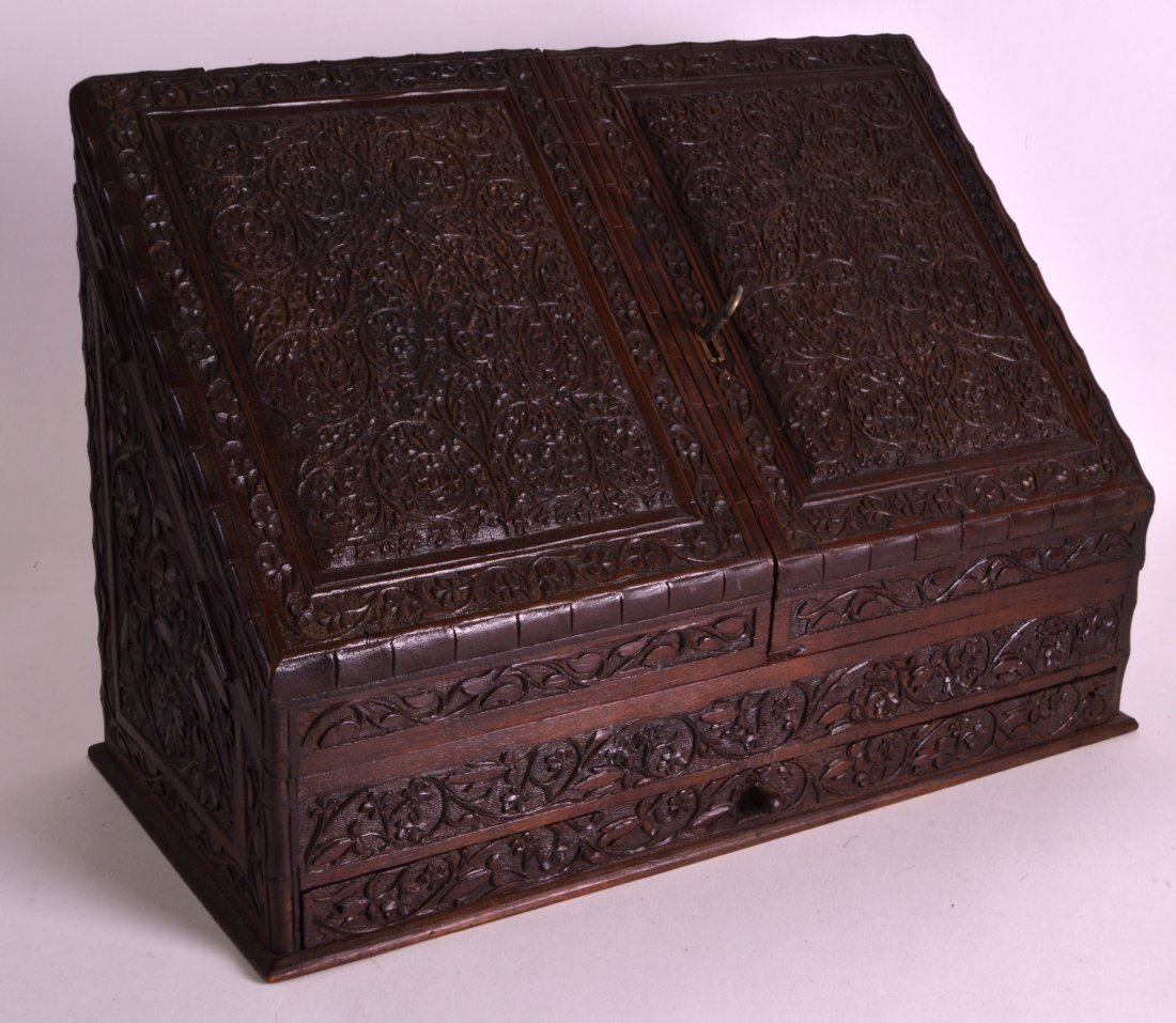 A 19TH CENTURY BLACK FOREST BAVARIAN DESK CABINET: A 19TH CENTURY BLACK FOREST BAVARIAN DESK CABINET carved with panels of elaborate foliage and vines. 15Ins x 12ins.