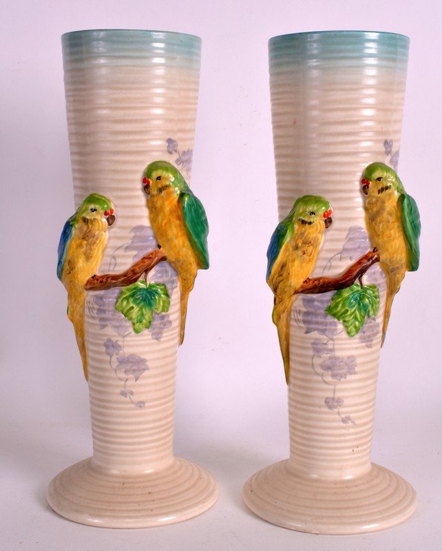 AN UNUSUAL PAIR OF 1940S CLARICE CLIFF RIBBED VASES: AN UNUSUAL PAIR OF 1940S CLARICE CLIFF RIBBED VASES surmounted with a brace of budgerigar upon stumps. 12.5ins high.