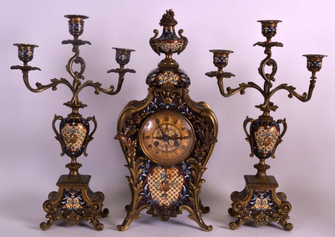 A LOVELY LATE 19TH CENTURY FRENCH GILT BRONZE AND: A LOVELY LATE 19TH CENTURY FRENCH GILT BRONZE AND CHAMPLEVE ENAMEL CLOCK GARNITURE retailed by Tiffany & Co New York. Clock 1ft 3.5ins high. (3)