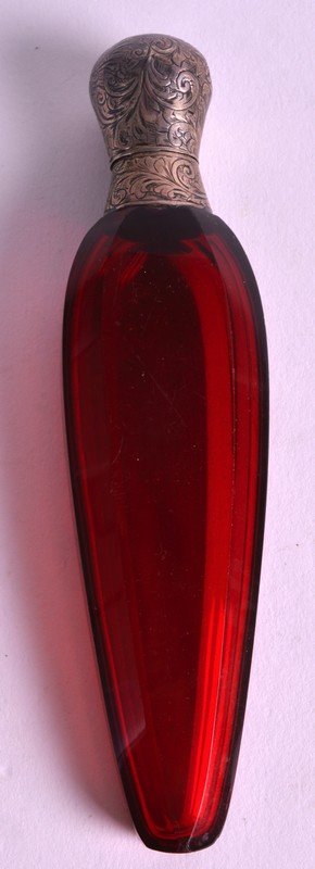A VICTORIAN SILVER MOUNTED RUBY GLASS 'TEAR DROP' SCENT: A VICTORIAN SILVER MOUNTED RUBY GLASS 'TEAR DROP' SCENT BOTTLE of facetted form. 4.75ins long.