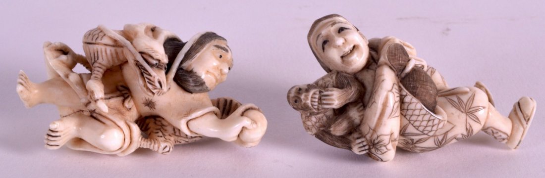 A PAIR OF EARLY 20TH CENTURY JAPANESE MEIJI PERIOD: A PAIR OF EARLY 20TH CENTURY JAPANESE MEIJI PERIOD IVORY NETSUKES one modelled with an entwined dragon, the other holding a monkey. 2.25ins high.