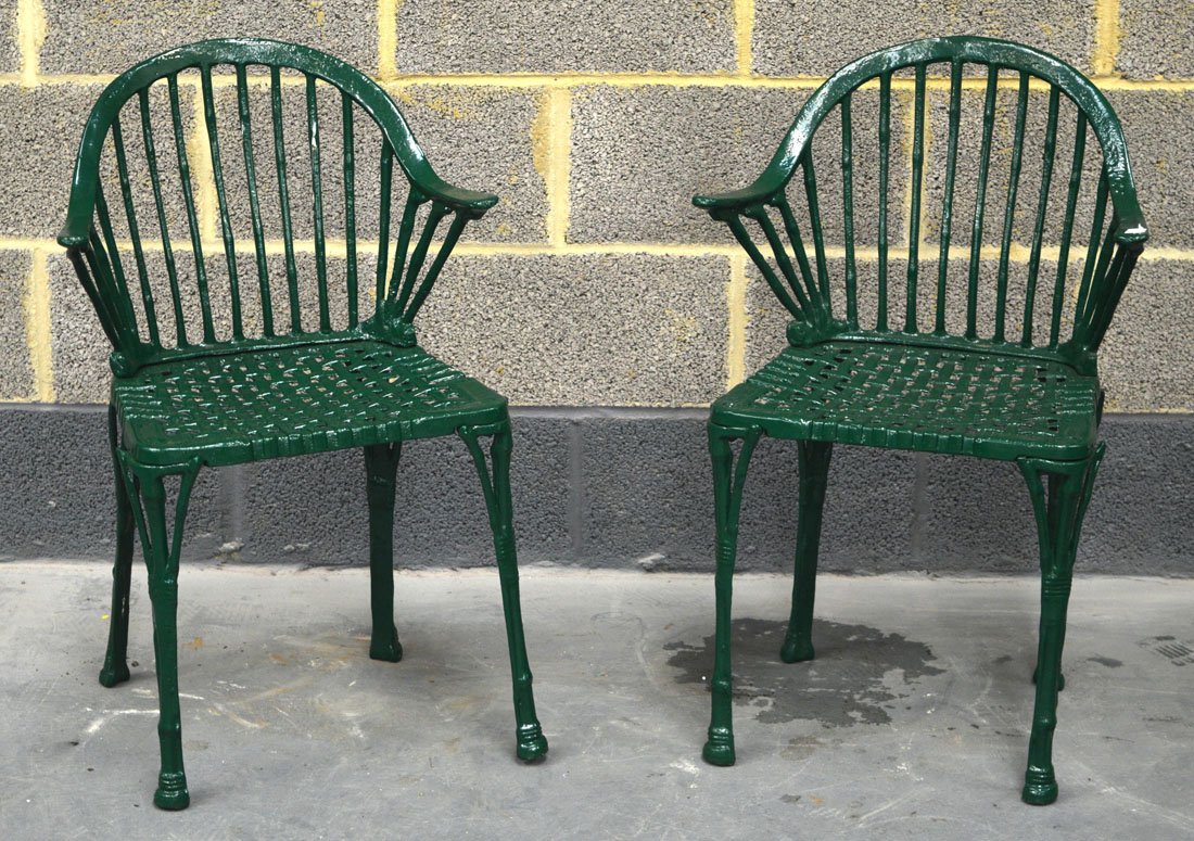 A PAIR OF VINTAGE GREEN PAINTED CAST IRON GARDEN: A PAIR OF VINTAGE GREEN PAINTED CAST IRON GARDEN CHAIRS.