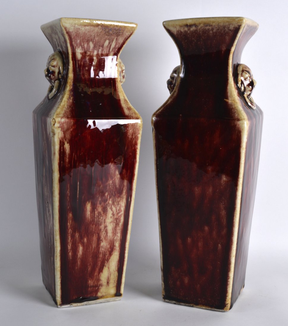 A PAIR OF LATE 19TH/20TH CENTURY CHINESE FLAMBE GLAZED: A PAIR OF LATE 19TH/20TH CENTURY CHINESE FLAMBE GLAZED SQUARE VASES with buddhistic mask head ring handles. 1Ft 4.5ins high.