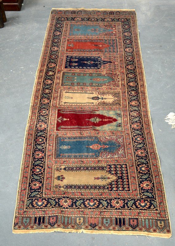 A PERSIAN ANTIQUE RUNNER decorated with various: A PERSIAN ANTIQUE RUNNER decorated with various coloured panels. 7Ft x 2ft 8ins.