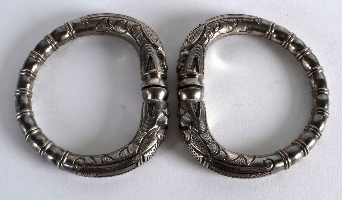 A GOOD PAIR OF CHINESE SILVERED BRONZE BANGLES modelled (1 of 2)