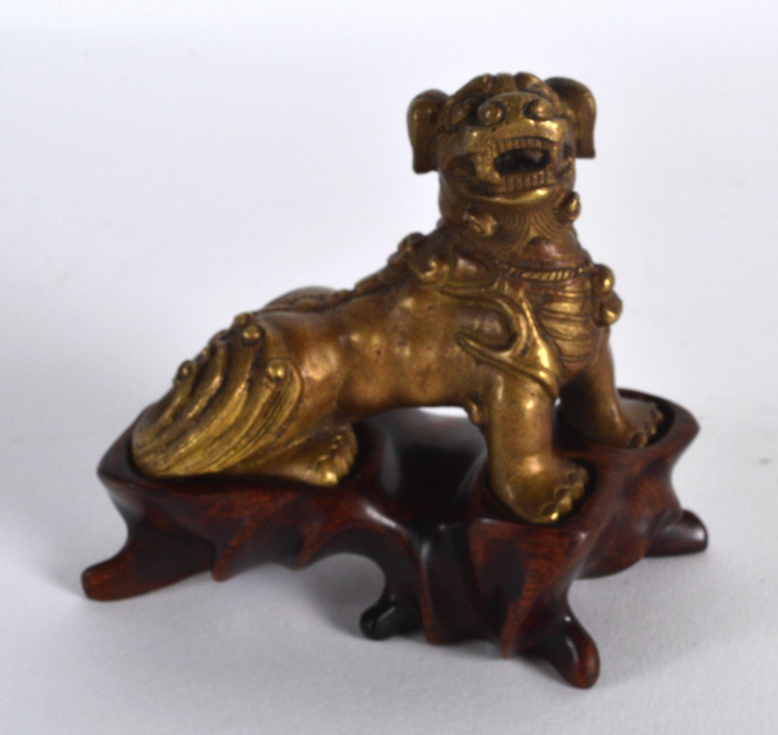 A CHINESE QING DYNASTY GILT BRONZE FIGURE OF A BEAST (1 of 2)