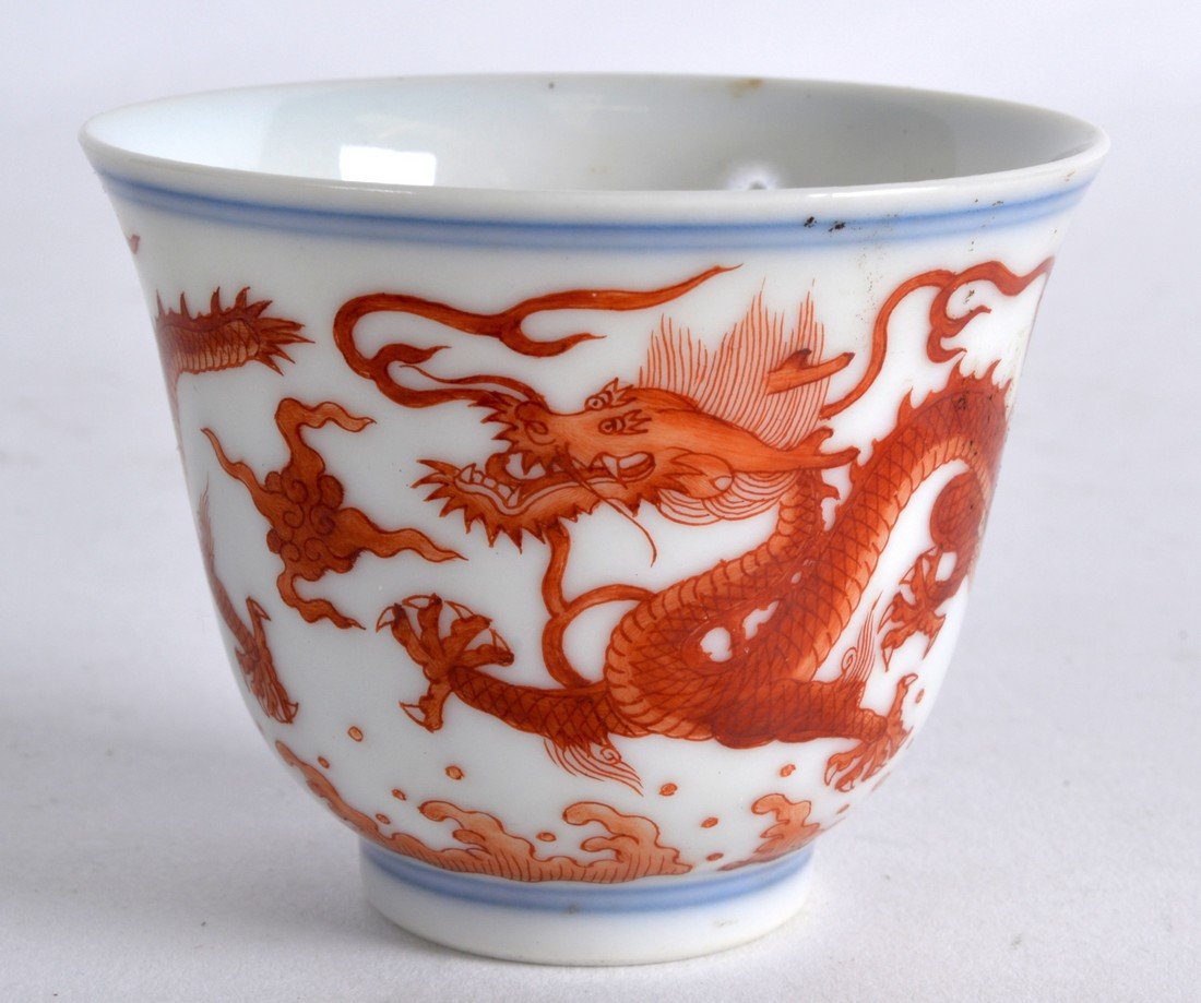 A GOOD CHINESE PORCELAIN IRON RED TEABOWL Xuantong mark: A GOOD CHINESE PORCELAIN IRON RED TEABOWL Xuantong mark and probably of the period, painted with dragons under a double blue line border. 2Ins high.