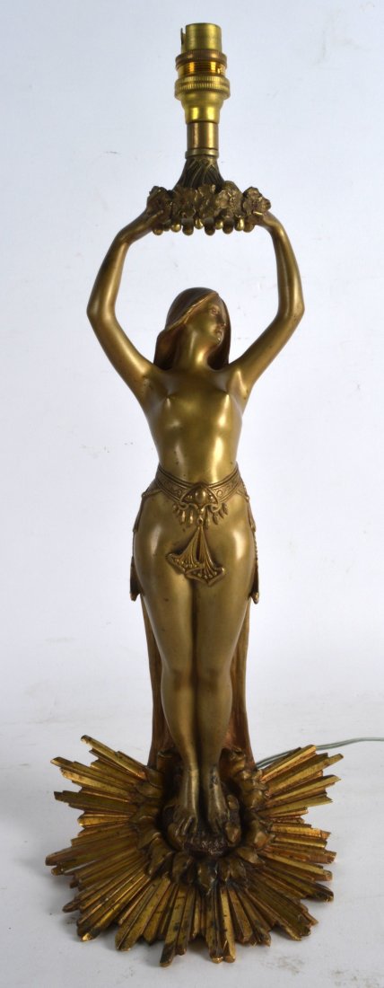A FINE ART NOUVEAU GILT BRONZE FIGURAL TABLE LAMP: A FINE ART NOUVEAU GILT BRONZE FIGURAL TABLE LAMP Attributed to Charles Emile Jonchery, modelled standing upon a starburst base. 1Ft 1ins high.