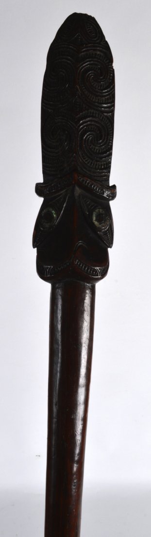 A RARE 18TH/19TH CENTURY MAORI TAIAHA carved from one: A RARE 18TH/19TH CENTURY MAORI TAIAHA carved from one piece of hardwood, with shell inset terminal and tapering shaft. 5ft 11ins long.