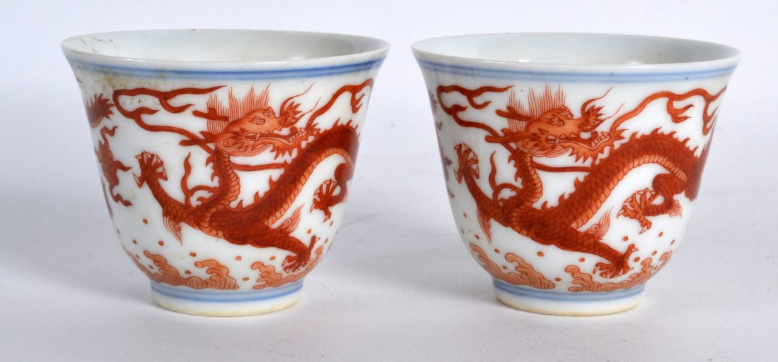 A PAIR OF EARLY 20TH CENTURY CHINESE IRON RED TEABOWLS: A PAIR OF EARLY 20TH CENTURY CHINESE IRON RED TEABOWLS bearing Xianfeng marks to base, painted with dragons. 2.25ins high.