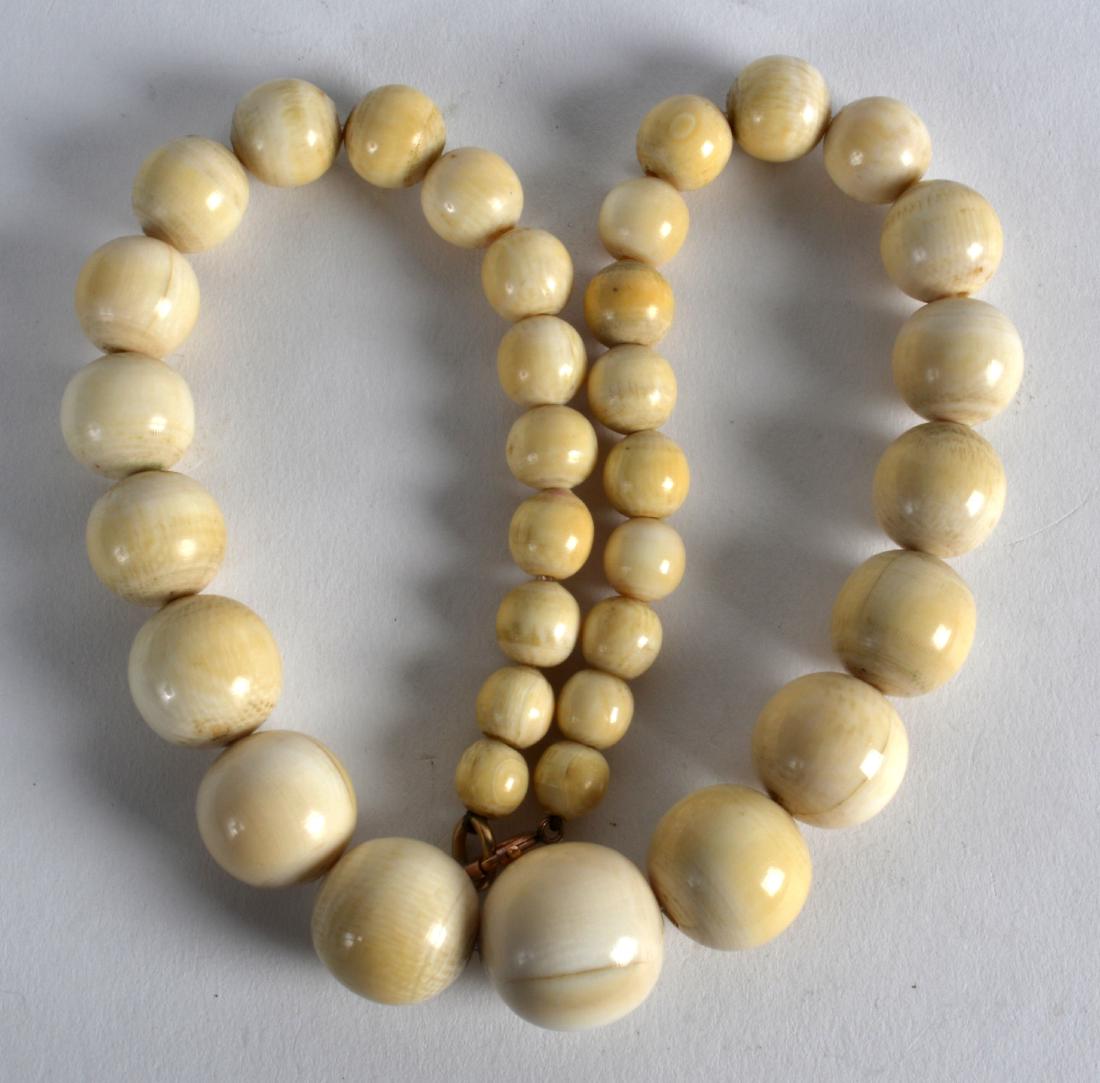 A 19TH CENTURY CARVED IVORY NECKLACE. (1 of 2)