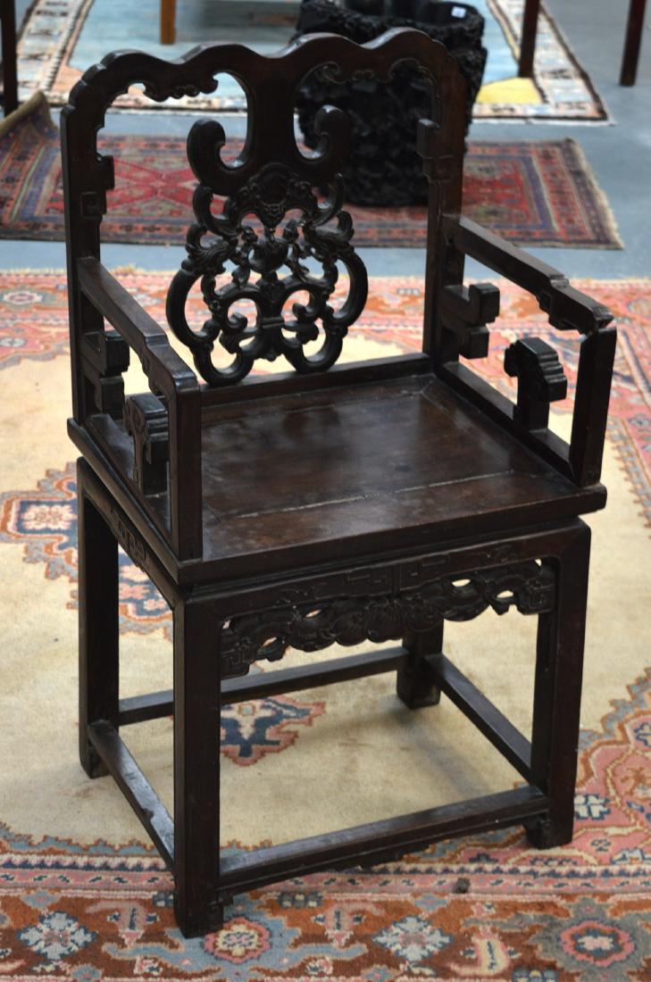 A 19TH CENTURY CHINESE CARVED HARDWOOD CHAIR with: A 19TH CENTURY CHINESE CARVED HARDWOOD CHAIR with shaped top and carved backsplat.