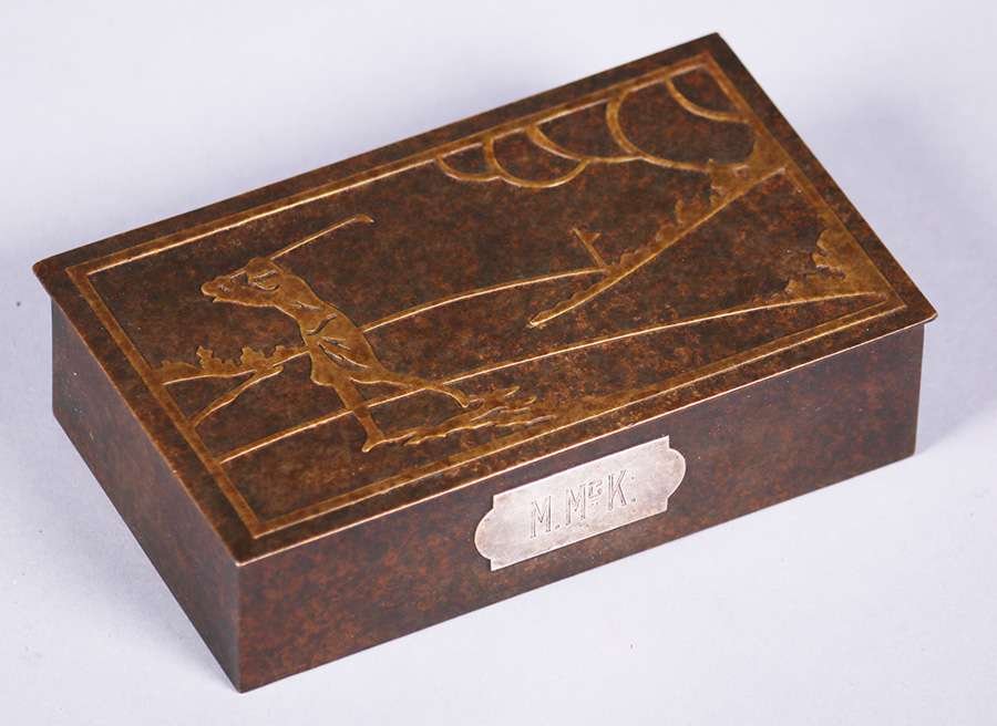 Silvercrest Bronze Box Woman Playing Golf: Silvercrest bronze box with a brass overlay design of a woman playing golf. Signed. Excellent new patina. 6.25"w x 3 5/8"d x 1 5/8"h. We box and ship ourselves, to keep shipping costs low. We do not u