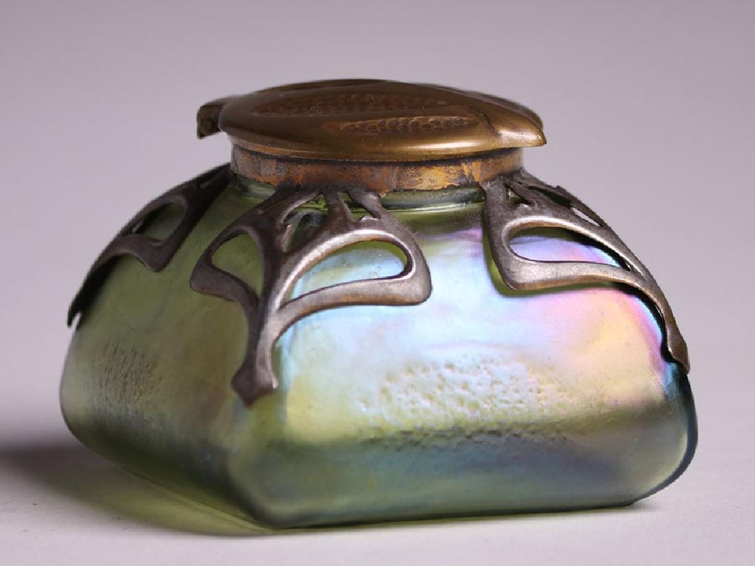 Loetz Green Glass Overlay Inkwell: Loetz green glass overlay inkwell with hammered brass top lid. Unsigned. Excellent condition. 325" x 3.25" x 2.5". Spend $5000 or more at this auction and all of your SHIPPING IS FREE within the lowe