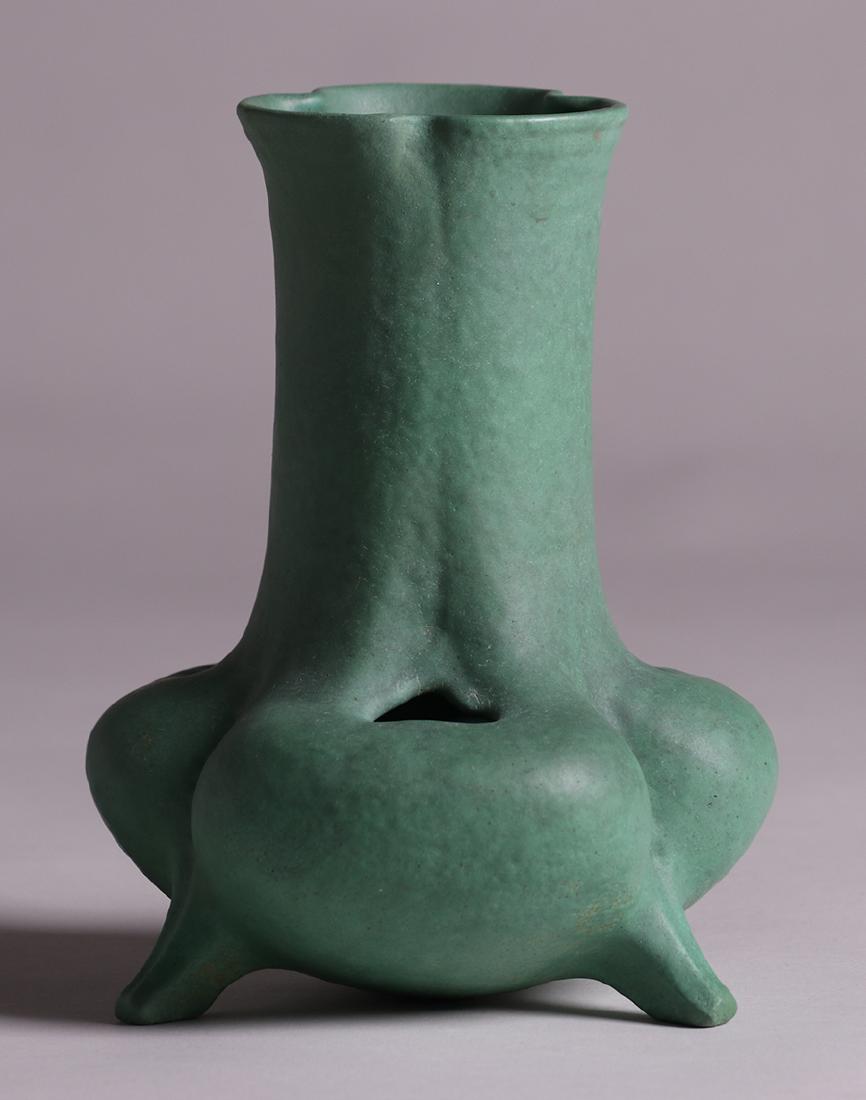 Rare Teco Pottery Organic Form Cutout Vase: Rare Teco Pottery organic cutout form vase with three raised legs. Glazed over signature. Invisible professional restoration. 9.25"h x 7"d. Spend $5000 or more at this auction and all of your SHIPPING