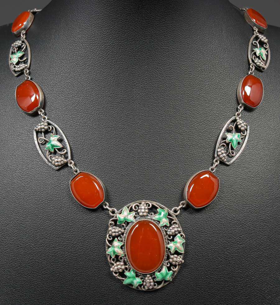 Arts & Crafts Period Sterling Silver, Carnelian & Enamel Necklace c1920: Arts & Crafts Period Sterling Silver, Carnelian & Enamel Necklace c1920. Unsigned. Bracelet and matching necklace sold separately. 14" length. Pendant: 1.25” x 1.25”. Spend $5000 or more a
