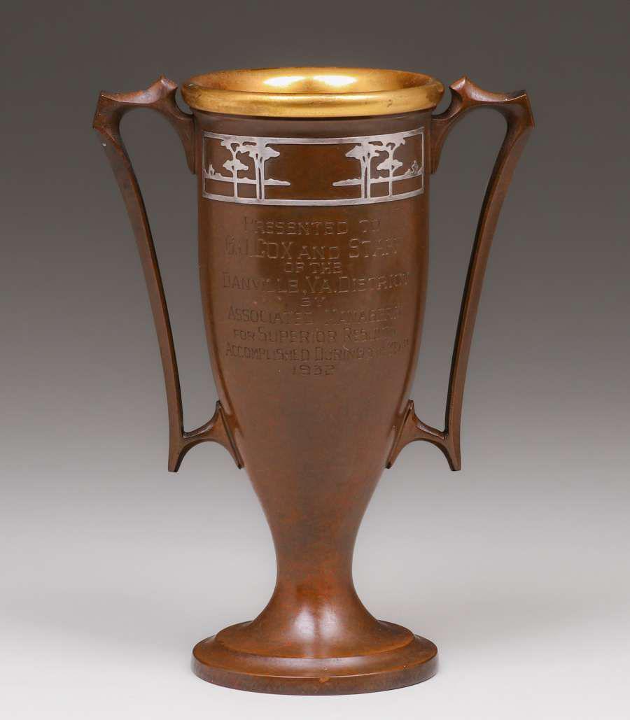 Silvercrest Sterling Silver on Bronze Overlay Two-Handled Trophy 1932: Silvercrest Sterling Silver on Bronze Overlay Two-Handled Trophy 1932. Signed. Excellent original patina. 8.25h x 6w. Spend $5000 or more at this auction and all of your SHIPPING IS FREE within the lo