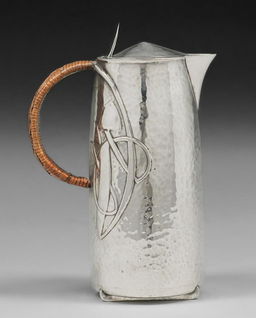 Liberty & Co Archibald Knox Petwer Pitcher c1900: Liberty & Co Archibald Knox Petwer Pitcher c1900. Signed. Excellent condition. 8.5"h x 5.75"w. Spend $5000 or more at this auction and all of your SHIPPING IS FREE within the lower 48 states. SHIPPING