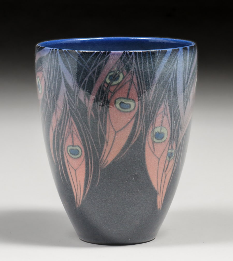 Rookwood Pottery Sara Sax Peacock Feather Jeweled Porcelain 1919: Rookwood Pottery Sara Sax Peacock Feather Jeweled Porcelain 1919. Signed. Tight line in rim almost appears to be a craze line, otherwise perfect condition. 6.5"h x 5 1/8"d. Spend $7500 or more at this