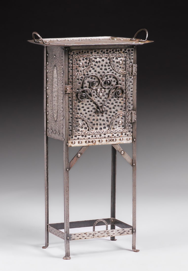 Hugo Berger - Goberg - German Silver-Plated Hand-Forged Iron Liquor Cabinet c1900s: Hugo Berger - Goberg - German Silver-Plated Hand-Forged Iron Liquor Cabinet c1900s. Holds 6 bottles of wine standing. Unsigned. Excellent original patina. 18"w x 11.25"d x 33 7/8"h (32.25"h to top sur