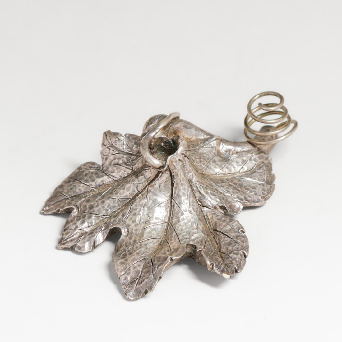Arts & Crafts Period Hammered Silver Oak Leaf Shaped Paperweight c1910s: Arts & Crafts Period Hammered Silver Oak Leaf Shaped Paperweight c1910s. Unsigned. This may have beeen a base to something that would have been inderted into it like a small glass tube to hold a