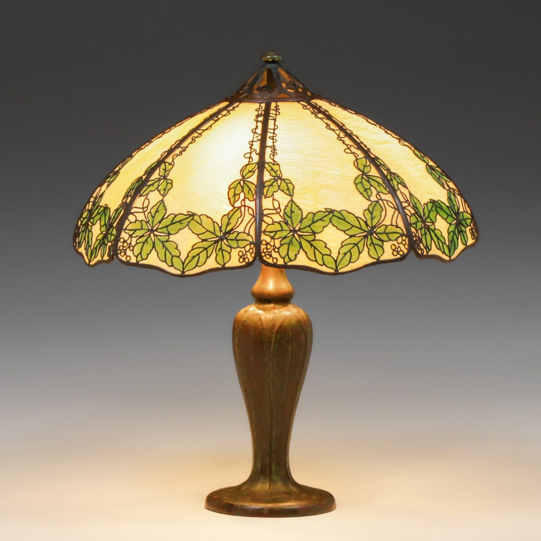 Handel Grapevine Leaves Overlay Lamp c1910: Handel Grapevine Leaves Overlay Lamp c1910. Signed. Excellent original bronze patina. Some minor breaks to overlay. Original curved glass panels in perfect condition. 23 5/8"d x 26.5"h FREE NATIONWIDE