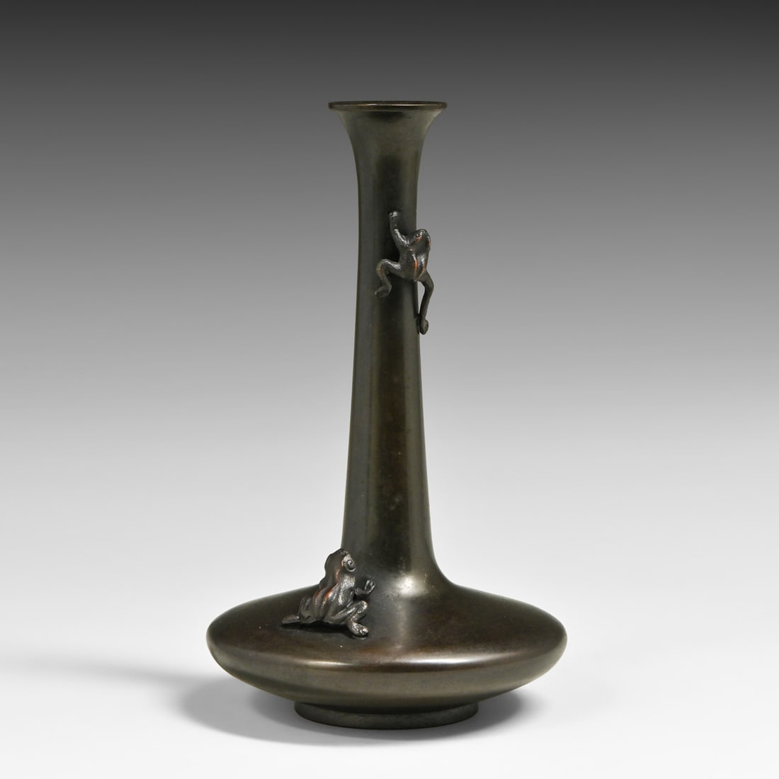 Japanese Meiji Period Patinated Bronze Garlic-Mouth Bud Vase c1900s: Japanese Meiji Period Patinated Bronze Garlic-Mouth Bud Vase c1900s. An exceptional, heavy lost-wax cast bronze flower vessel featuring two masterfully sculpted high-relief frogs climbing the neck and