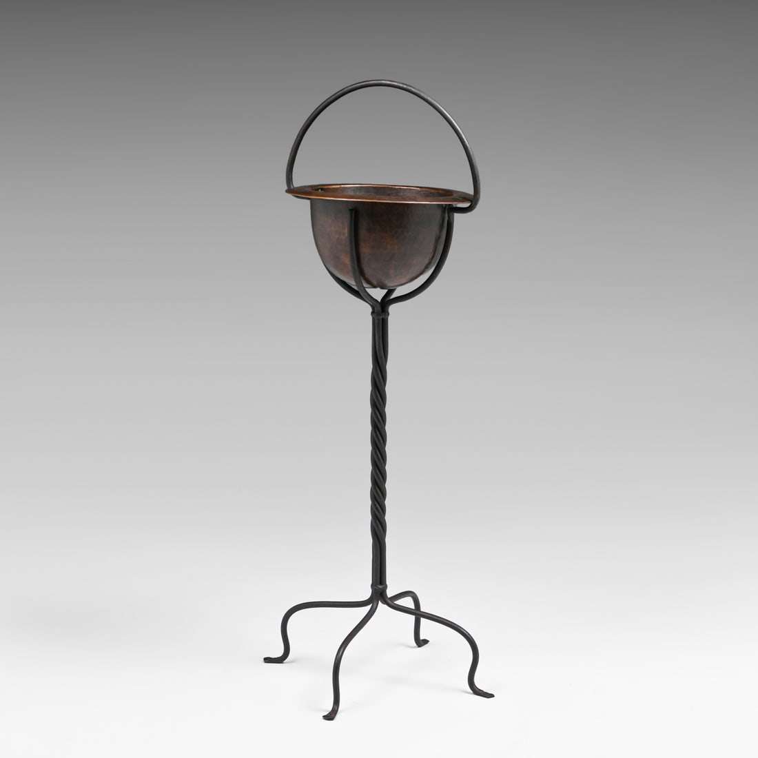 Harry St John Dixon Hammered Copper & Hand-Forged Iron Plant Stand after 1925: Harry St John Dixon Hammered Copper & Hand-Forged Iron Plant Stand after 1925. Signed with impressed mark under edge of copper basin. Basin repatinated. Iron has its original patina. 29"h 11"d x 12"w 